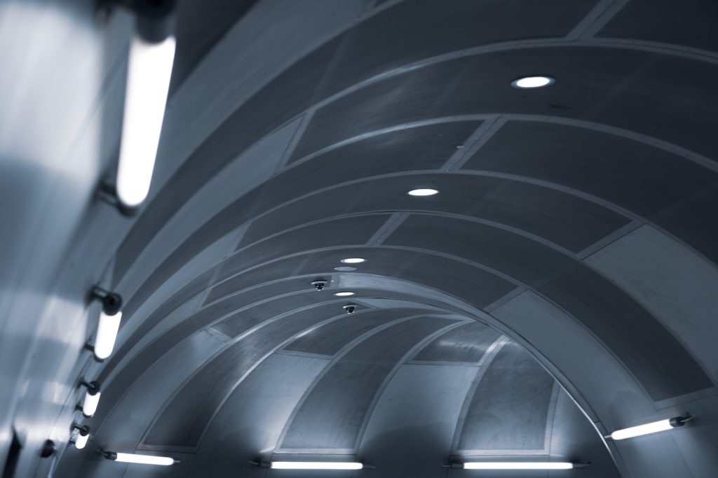 the ceiling of a subway station with lights